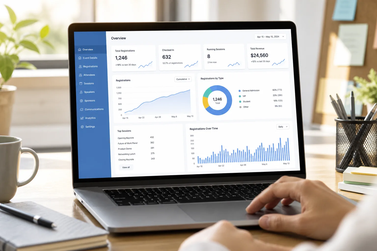 Laptop showing an event platform dashboard with ticket sales, agenda management, and attendee analytics
