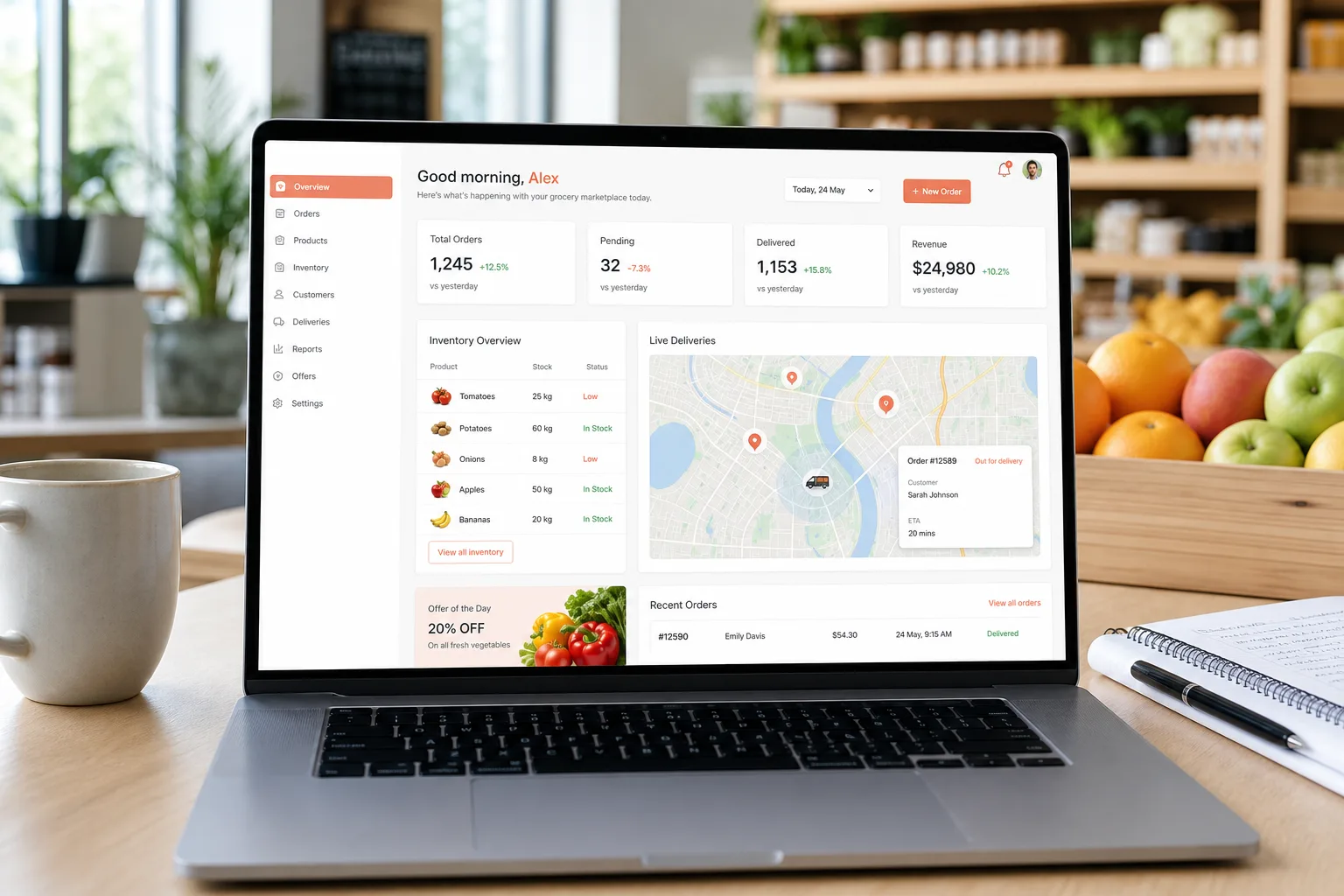 Laptop showing a grocery delivery platform dashboard with orders, inventory status, and delivery tracking